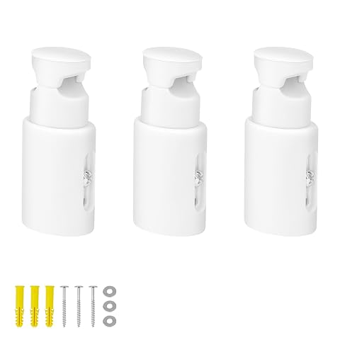 Trois supports muraux blancs avec écrous et entretoises près d’un sèche-serviettes.